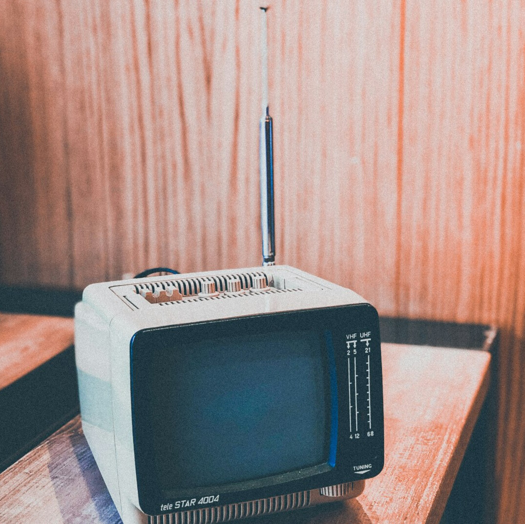 Vintage cathode-ray television set showing colour bars in a 1980s living room