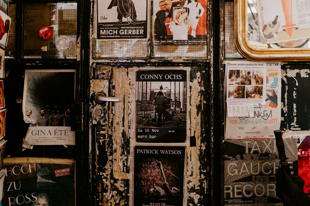 Collection of vintage printed posters and magazines spread on a table
